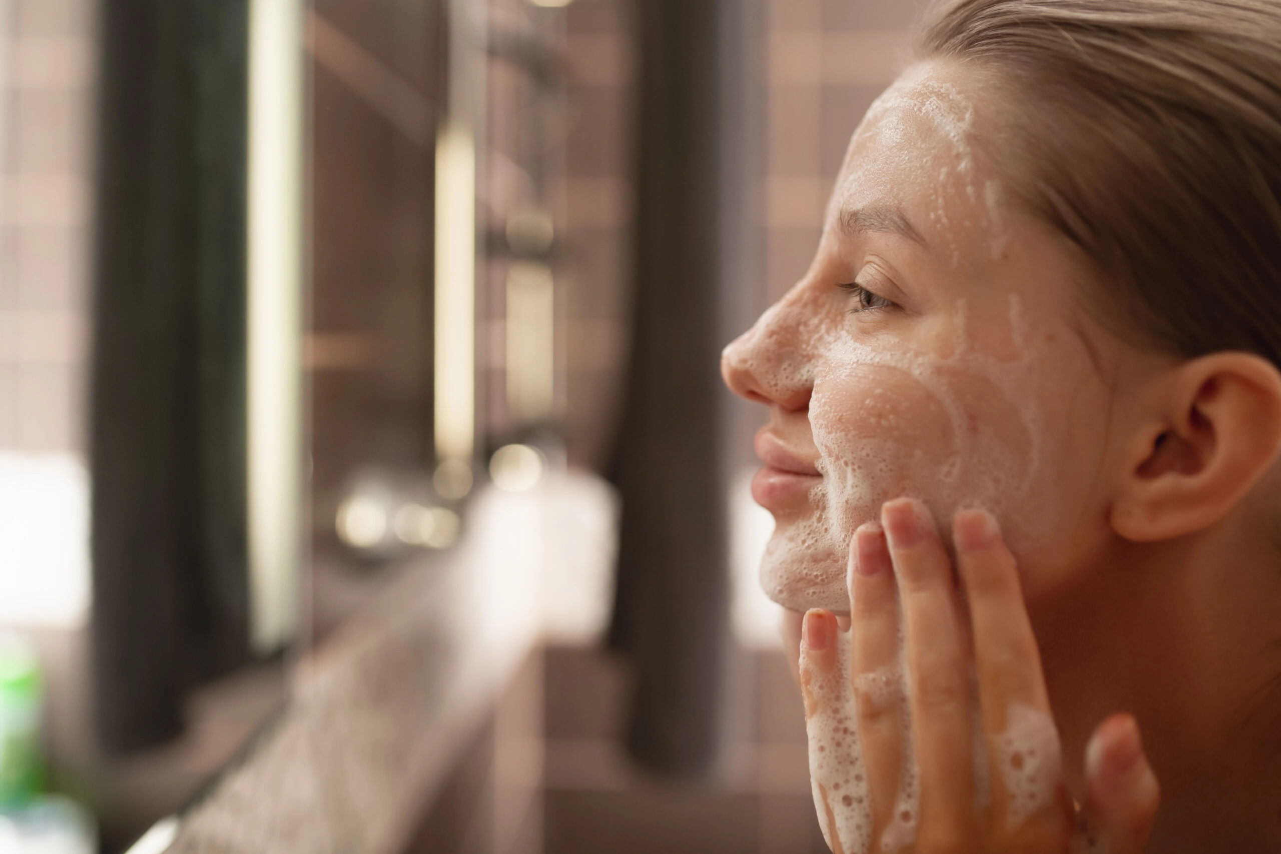 smiling woman washing her face